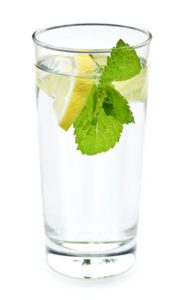 beautiful glass of lemon water with herbs